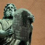 Statue of Moses bearing the 10 Commandments in a courtroom.