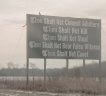 A sign on the side of the highway with some of the ten commandments on it.